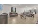 Open-concept living room flowing into a modern kitchen with stainless steel appliances at 123 Zinnia W Ln, Poinciana, FL 34759