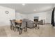Open-concept living room featuring neutral decor, tiled floors, and versatile layout at 123 Zinnia W Ln, Poinciana, FL 34759