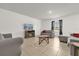 Cozy living room with neutral tones, tile flooring, and comfortable seating arrangement at 123 Zinnia W Ln, Poinciana, FL 34759