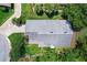 Aerial view of the home showing the roof, landscaping, and surrounding trees at 125 W Wyndham Ct, Longwood, FL 32779