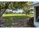 Scenic backyard view showcasing a lush lawn, mature trees, and a glimpse of the golf course at 125 W Wyndham Ct, Longwood, FL 32779
