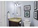Elegant bathroom features a vanity with granite countertop and art at 125 W Wyndham Ct, Longwood, FL 32779