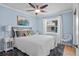 Cozy bedroom featuring blue walls, neutral furniture, and natural light at 125 W Wyndham Ct, Longwood, FL 32779