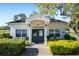 Exterior of community center with green doors and manicured bushes at 125 W Wyndham Ct, Longwood, FL 32779