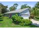 Attractive single-story home with lush landscaping, well-manicured lawn, and two-car garage at 125 W Wyndham Ct, Longwood, FL 32779
