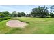 Well maintained golf course, with manicured green and white sand trap at 125 W Wyndham Ct, Longwood, FL 32779