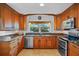 Well-equipped kitchen with granite counters, stainless steel appliances, and wooden cabinetry at 125 W Wyndham Ct, Longwood, FL 32779