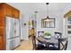 Bright kitchen with stainless steel refrigerator and cozy breakfast nook area with stylish pendant light at 125 W Wyndham Ct, Longwood, FL 32779