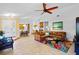 Open-concept living room, featuring a neutral tile floor and comfortable seating at 125 W Wyndham Ct, Longwood, FL 32779