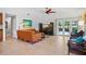 Spacious living room featuring neutral tile flooring, modern furniture, and lots of light at 125 W Wyndham Ct, Longwood, FL 32779