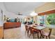 Open-concept living space with dining area, comfortable seating, and a view of the backyard at 125 W Wyndham Ct, Longwood, FL 32779