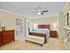 Inviting main bedroom with neutral tones, ceiling fan, and a decorative map wall art at 125 W Wyndham Ct, Longwood, FL 32779