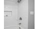 Clean, new tile inside shower with shower head and handle at 125 W Wyndham Ct, Longwood, FL 32779