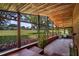 Large sunroom featuring wood paneled walls and ceilings, tile floors, and views of the backyard and golf course at 125 W Wyndham Ct, Longwood, FL 32779
