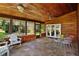 Beautiful sunroom featuring wood paneled walls and ceilings, tile floors, and floor to ceiling windows at 125 W Wyndham Ct, Longwood, FL 32779