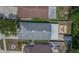 Aerial view of a fenced in backyard patio with firepit and chairs, detached storage shed, and covered patio at 13169 Odyssey Lake Way, Orlando, FL 32826