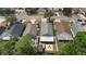 Aerial view of single Gathering homes, fenced yards, and a patio with firepit and chairs at 13169 Odyssey Lake Way, Orlando, FL 32826