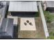 Aerial view of the private fenced backyard featuring a fire pit, covered patio, and a storage shed at 13169 Odyssey Lake Way, Orlando, FL 32826