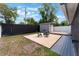 Backyard features a seating area and storage shed, enclosed by a fence at 13169 Odyssey Lake Way, Orlando, FL 32826