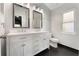 Bathroom features a double sink vanity with a white countertop and framed mirrors at 13169 Odyssey Lake Way, Orlando, FL 32826
