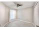 Bedroom featuring a ceiling fan, tile floors, and white walls at 13169 Odyssey Lake Way, Orlando, FL 32826