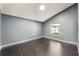Bedroom featuring hardwood floors, natural light, and soft gray walls at 13169 Odyssey Lake Way, Orlando, FL 32826