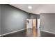 Bedroom featuring hardwood floors and three doorways, including access to a bathroom at 13169 Odyssey Lake Way, Orlando, FL 32826