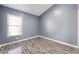 Bedroom with light blue walls and wood-look floors at 13169 Odyssey Lake Way, Orlando, FL 32826