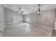 A living room featuring light gray walls, a ceiling fan, and sliding glass doors at 13169 Odyssey Lake Way, Orlando, FL 32826