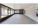 A spacious screened patio featuring concrete floors, screen walls, and outdoor access at 13169 Odyssey Lake Way, Orlando, FL 32826