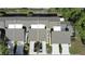 Aerial view of townhomes showcasing the rooftops, driveways and surrounding landscape of the neighborhood at 136 Teriwood Ct, Fern Park, FL 32730