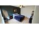 Comfortable bedroom with a dark green accent wall, natural light, and wood-look floors at 136 Teriwood Ct, Fern Park, FL 32730