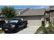 Charming townhome featuring a one-car garage, manicured lawn, and patriotic American flag display at 136 Teriwood Ct, Fern Park, FL 32730