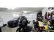 Spacious two-car garage equipped with motorcycle, shelving, and ample storage space at 136 Teriwood Ct, Fern Park, FL 32730