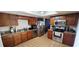 Modern kitchen with stainless steel appliances, wooden cabinetry and tile floors with ample counter space at 136 Teriwood Ct, Fern Park, FL 32730