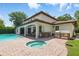 Backyard featuring outdoor kitchen, hot tub, pool, covered patio, and lush landscaping at 1361 Palmer Ave., Winter Park, FL 32789