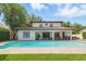Stunning backyard features a large pool, brick patio, outdoor kitchen, and covered seating area at 1361 Palmer Ave., Winter Park, FL 32789