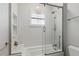 Bathroom featuring glass-enclosed shower and tub, with white tile and built-in shelving at 1361 Palmer Ave., Winter Park, FL 32789