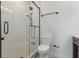 Bathroom featuring glass-enclosed shower with white marble-style tile and black trim with nearby toilet at 1361 Palmer Ave., Winter Park, FL 32789