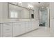 Bright bathroom featuring a double vanity, white cabinetry, and a large mirror at 1361 Palmer Ave., Winter Park, FL 32789