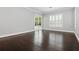 Spacious bedroom features wood floors, and sliding glass doors lead to a patio with a pool at 1361 Palmer Ave., Winter Park, FL 32789