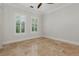 Bright bedroom featuring polished floors, white walls, and large windows with plantation shutters at 1361 Palmer Ave., Winter Park, FL 32789