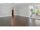 Spacious, empty bedroom with dark wood floors, arched doorway and glass doors to a patio at 1361 Palmer Ave., Winter Park, FL 32789
