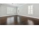 Bright, empty bedroom showcases dark wood floors and shuttered windows providing lots of natural light at 1361 Palmer Ave., Winter Park, FL 32789