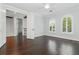 Spacious bedroom featuring dark hardwood floors, bright shuttered windows and access to hallway at 1361 Palmer Ave., Winter Park, FL 32789
