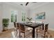 Bright dining room with a contemporary light fixture, plantation shutters and neutral colors at 1361 Palmer Ave., Winter Park, FL 32789