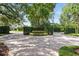 Circular driveway featuring a brick paver design and lush landscaping providing privacy at 1361 Palmer Ave., Winter Park, FL 32789
