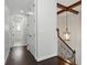 Hallway with hardwood floors, ceiling beams, and staircase, showcasing the home's architectural details at 1361 Palmer Ave., Winter Park, FL 32789