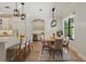 Modern kitchen and dining area with white cabinetry, stainless steel appliances, and stylish pendant lighting at 1361 Palmer Ave., Winter Park, FL 32789
