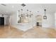 Open kitchen with white cabinets, center island, wine fridge, and pendant lighting, ideal for entertaining at 1361 Palmer Ave., Winter Park, FL 32789